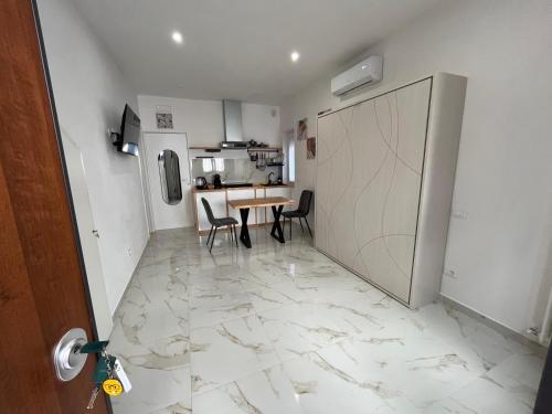 a kitchen and dining room with a table and chairs at RoomSovama in Pescara