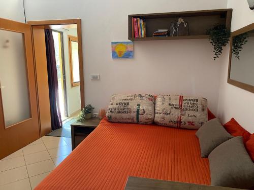 a living room with a couch with an orange rug at Apartma Izola in Izola