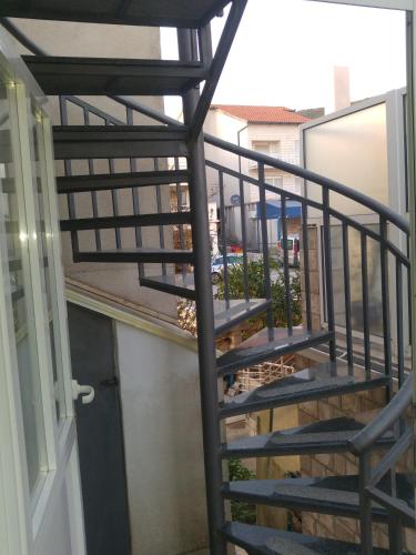 a spiral staircase on a balcony of a house at Apartments&Rooms SB in Neum