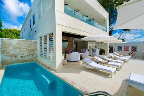 an image of a house with a swimming pool at Solaris Beach House - Beachfront Property, St James in Saint James