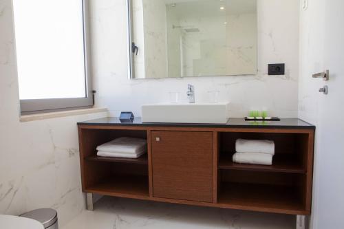 a bathroom with a sink and a mirror at Andon Lapa Hotel & Spa in Sarandë