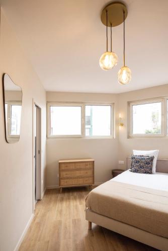 une chambre avec un lit et deux fenêtres dans l'établissement Peaceful and comfortable studio Paris 19- II, à Le Pré-Saint-Gervais