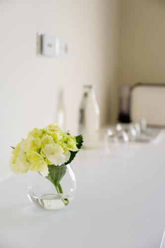 a vase of flowers sitting on a bathroom sink at Palazzo Gargiulo Luxury Rooms & Suites in Sorrento
