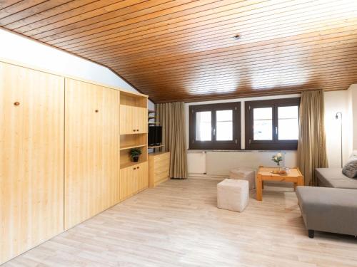 een woonkamer met een bank en een tafel bij Apartment Gamat 49 by Interhome in Villars-sur-Ollon