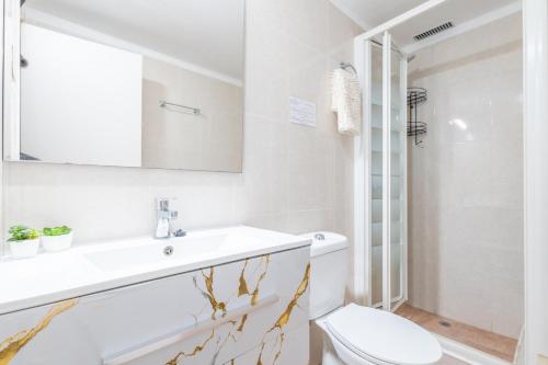 a bathroom with a sink and a toilet at Sol in Port d'Alcudia