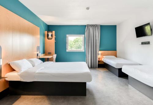Postel nebo postele na pokoji v ubytování B&B HOTEL Montpellier Centre Le Millénaire