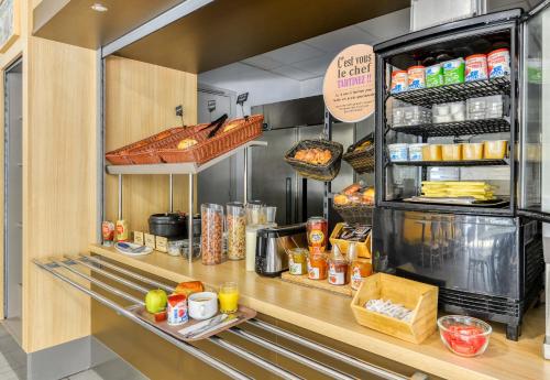 a kitchen with a counter with food on it at B&B HOTEL Montpellier Centre Le Millénaire in Montpellier