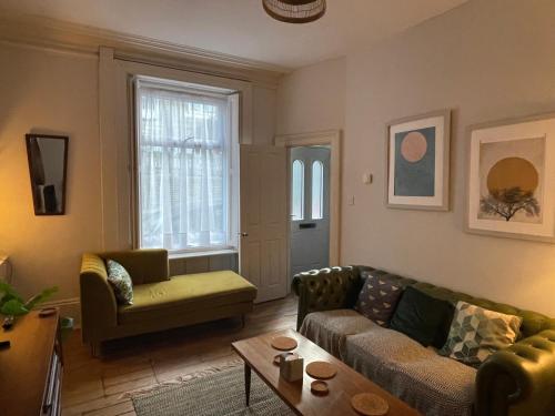 a living room with a couch and a table at Little Hebden Bridge House in Hebden Bridge