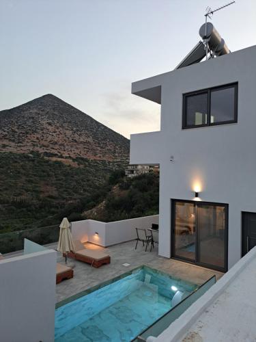 a house with a swimming pool on the roof at White Boutique Homes - Serenity in Metókhion Apisianá