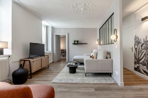 un salon avec un canapé et une télévision dans l'établissement 43#Opera # Grand Boulevards # 4BedRooms # Paris 02 # AC, à Paris