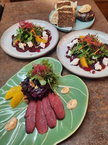 a table with three plates of food on it at Hotel & Restaurant Sonnenhöfle in Sommerhausen