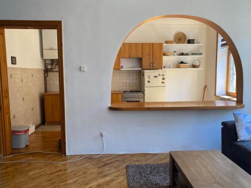 a living room with a kitchen and an archway in a room at Rio Apartment Old Town Sarajevo in Sarajevo