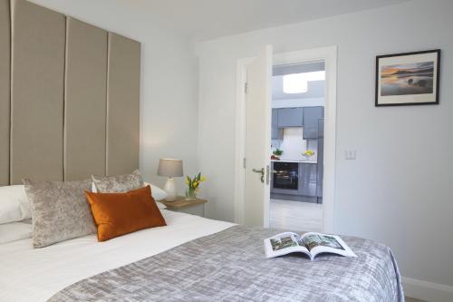 a bedroom with a bed with two books on it at Westport Heights Apartments in Westport