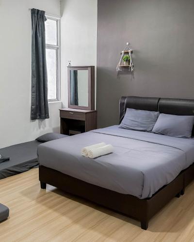 a bedroom with a bed and a mirror and a window at Sunset Haven Taiping Homestay near Lake Garden TPG in Taiping