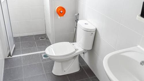 a bathroom with a white toilet and a sink at Sunset Haven Taiping Homestay near Lake Garden TPG in Taiping