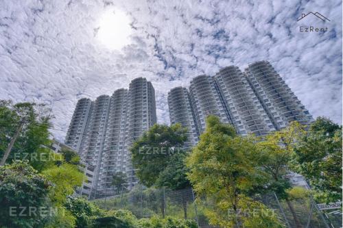 a group of tall buildings with a cloudy sky at Sunset Haven Taiping Homestay near Lake Garden TPG in Taiping