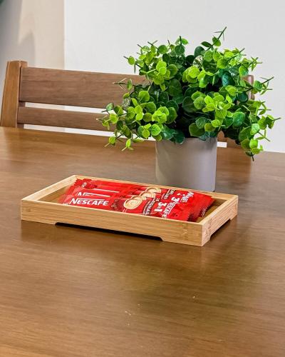 a box of coke on a table next to a plant at Sunset Haven Taiping Homestay near Lake Garden TPG in Taiping