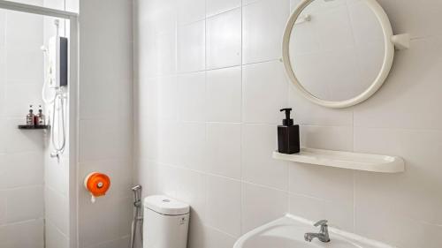 a white bathroom with a sink and a mirror at Sunset Haven Taiping Homestay near Lake Garden TPG in Taiping