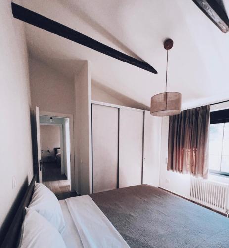a bedroom with a bed and a ceiling fan at ALFIEA HOME 65m2 & ALFIEA STUDIO 35m2 in Artemida
