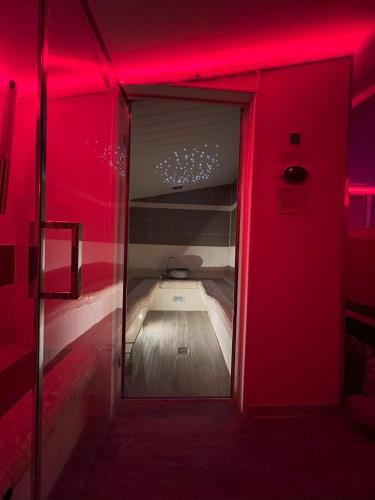 a room with a red lighted room with a small room with at Love Room du Mas de Saillac in Lavaurette