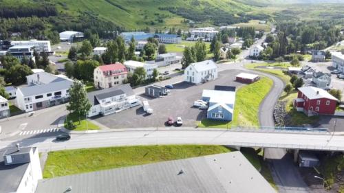 an aerial view of a small town with a road and houses at Askja Apartment in Húsavík
