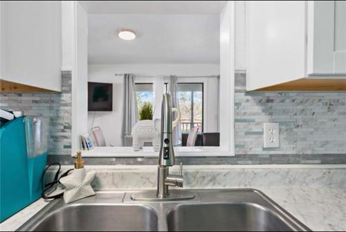 a kitchen with a sink and a mirror at Bradenton Breeze Near Beach in Bradenton