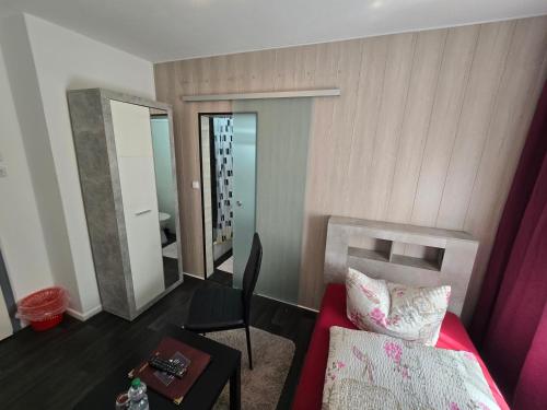 a bedroom with a bed and a table and a mirror at Pension Hamburg in Bad Grund