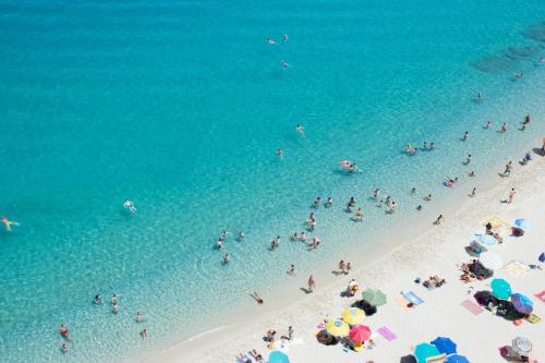 a group of people on a beach in the water at PLAZA Boutique Hotel - Tropea in Tropea