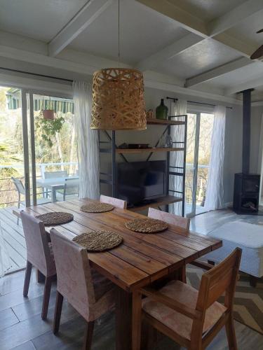 a dining room with a wooden table and chairs at Punta Horizonte Cabin in San José de Maipo