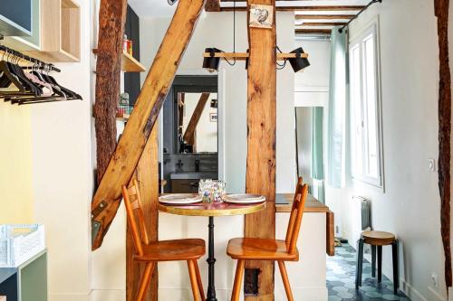 une salle à manger avec une table et deux chaises dans l'établissement Ideal pour 2 Appartement Rue Caffarelli, à Paris