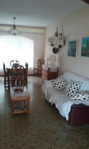 a bedroom with a bed and a table and chairs at Hotel la Masia in Portbou