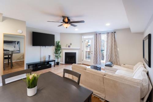 a living room with a couch and a table at Modern 3BR Retreat with BBQ & Smart TV in Baltimore