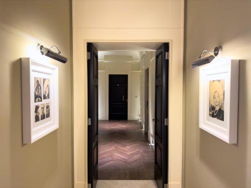 a hallway with two pictures on the walls and two lights at Relais Il Santissimo in Turi