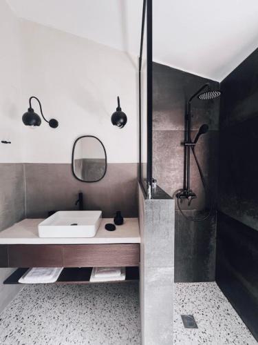 a bathroom with a sink and a shower at ALFIEA HOME 65m2 & ALFIEA STUDIO 35m2 in Artemida