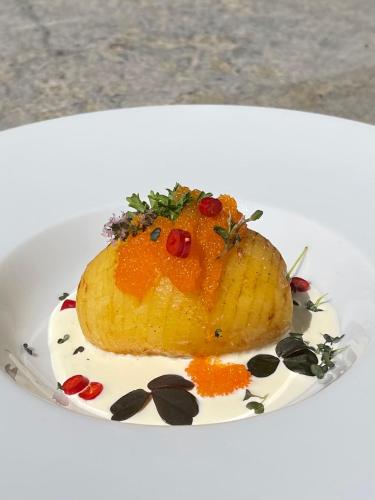 a piece of fruit on a white plate at Kivikstrand Badhotell in Kivik