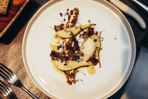 a white plate with a dessert on a table at The Peacock at Rowsley in Great Rowsley