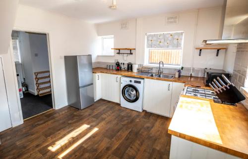 a kitchen with a sink and a dishwasher at 3 Bed Home - Sleeps 8 - Stoke City fc - Parking in Stoke on Trent