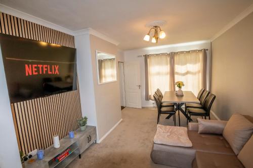 a living room with a couch and a table at 3 Bed Home - Sleeps 8 - Stoke City fc - Parking in Stoke on Trent