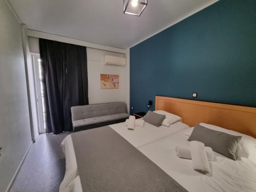 a small room with a bed and a couch at Savoy Hotel in Piraeus
