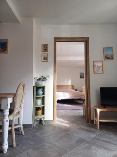 a room with a door leading to a bedroom at À côté du Pont Vieux - By the Old Bridge in Sospel