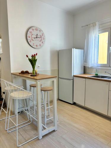 a kitchen with a table and a refrigerator at Casa Daphne in (( Agía Eleoúsa ))