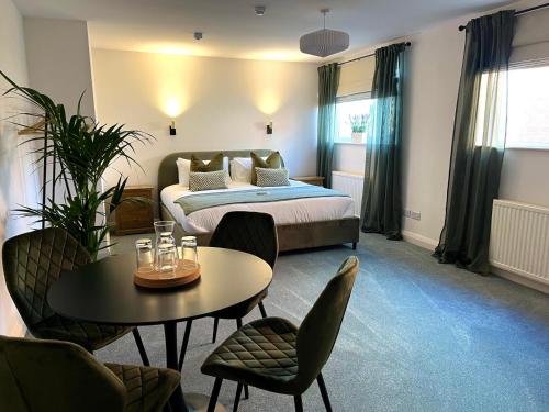 a bedroom with a bed and a table and chairs at The Briarcroft in Goole