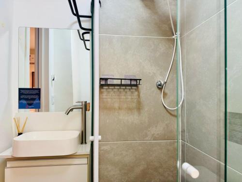 a bathroom with a sink and a shower at Modern Studio in Catete – Close to the Metro in Rio de Janeiro