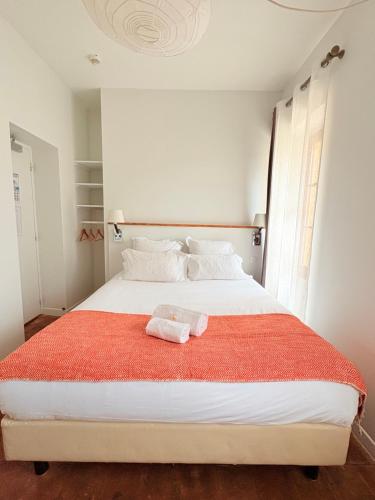 a bedroom with a large white bed with a red blanket at Domaine Gaogaia in Aix-en-Provence