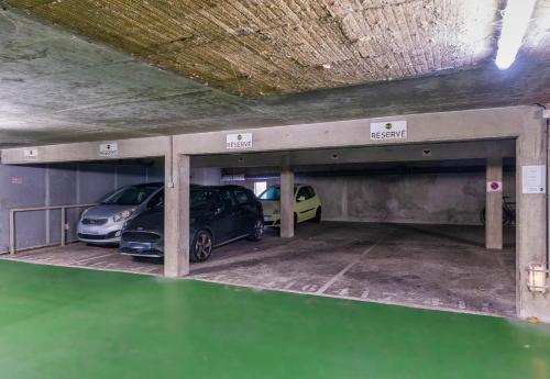 a garage with two cars parked in it at B&B HOTEL Lyon Centre Part-dieu Gambetta in Lyon