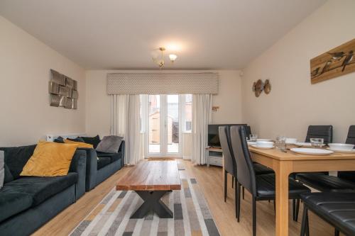 a living room with a couch and a table at Lovely refurbed 4 bed house in Black Country in Tipton