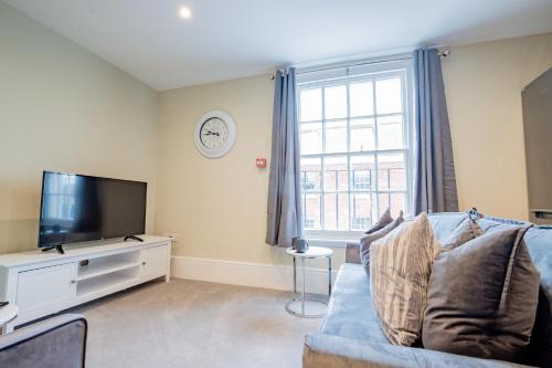 a living room with a blue couch and a tv at WhiskAwayHomes - Shaw Street - Apartment 8 in Worcester