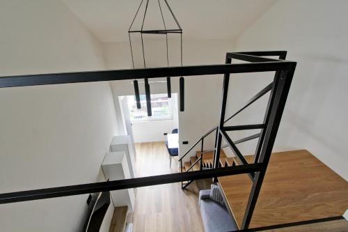 a staircase in a house with a black railing at Luxury loft Cassia in Rome