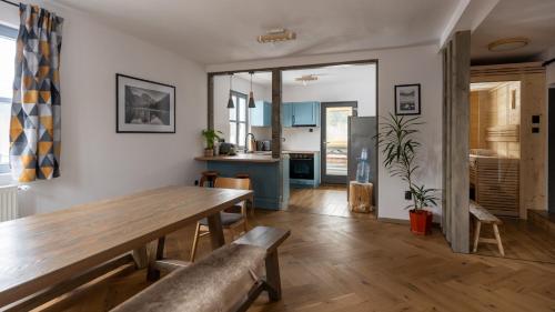 a kitchen and dining room with a wooden table at Mountain Air Lodge in Izvoru Mureşului