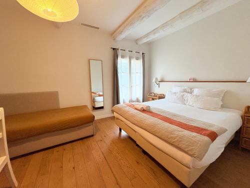 a bedroom with a large bed and a window at Domaine Gaogaia in Aix-en-Provence